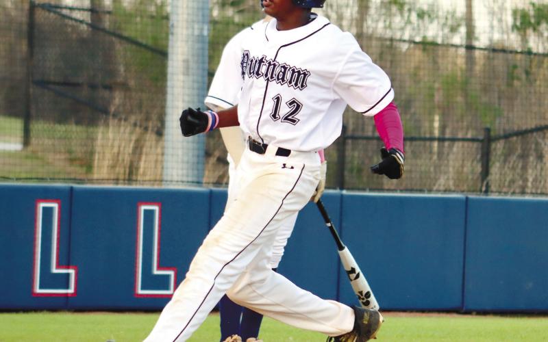 BJ Ruff (12) crosses the plate safely for another run against the Bulldogs. ARELLA CASH/Staff