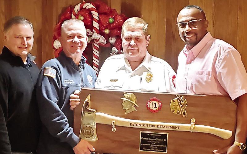 Eatonton Fire Department’s Cooper Rainey, Lt. Jamie Williamson, Assistant Chief Joey Davis, Assistant Chief Carl Buckner and Lt. Carl Vining present Chief Eugene Hubert with his retirement plaque. CONTRIBUTED