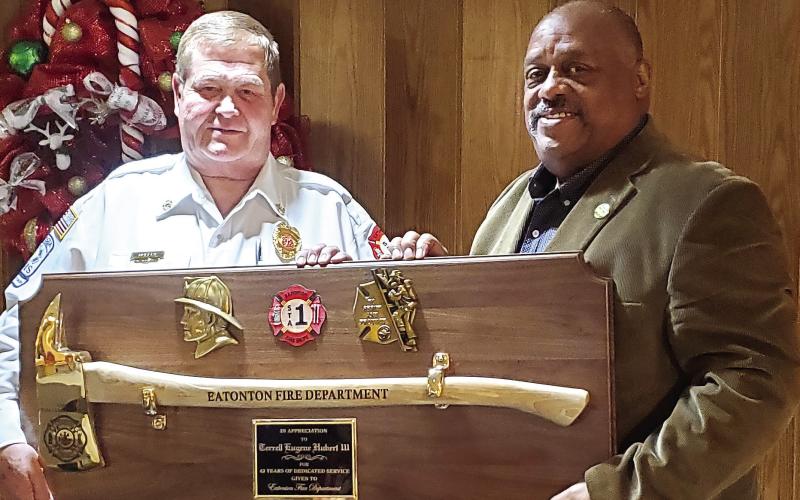 Eatonton Fire Department’s retired Chief Eugene Hubert is thanked by Eatonton Mayor John Reid. CONTRIBUTED