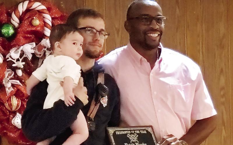Eatonton Fire Department Asst. Chief Carl Buckner, right, recognizes firefighter David Hooks as Firefighter of the Year. CONTRIBUTED