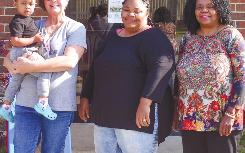 From left to right, volunteer Shelby Beauchamp holding Mazi Mathis, volunteer Lynda Farley and Executive Director Vanessa Jackson. BAILEY BALLARD/Staff