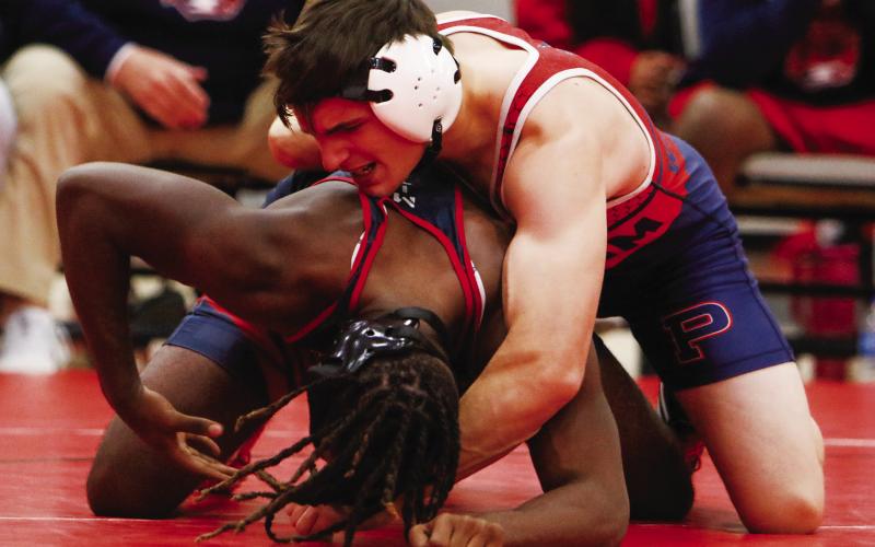 Putnam County senior Wyatt Suggs tries to pin his opponent from Southwest (Macon) at the area duals tournament last Thursday in Social Circle. LANCE McCURLEY/ Staff