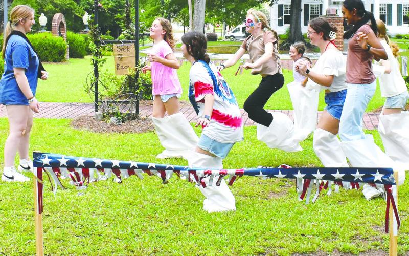 A group of girls compete in a sack race. LENA HENSLEY/Staff