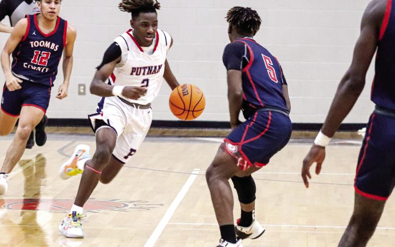 Landon Bonner (2) brings the ball up the floor in transition during a first-round playoff against Toombs County on Feb. 22. LANCE McCURLEY/Staff
