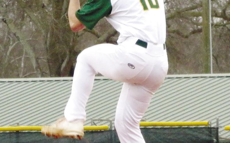 Wilson Moore (10) gets set from the bump as he prepares to deliver a pitch. TREY NORRIS/Staff