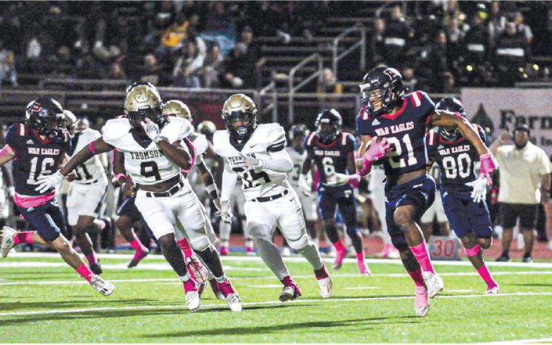 With support from teammates Ethan Whatley (16), Mark Little (6) and Jason Clemons (80), Putnam County senior Alan Hill (21) makes a run around the Thomson defense in a game played earlier this season. CHARLES JORDAN/File photo