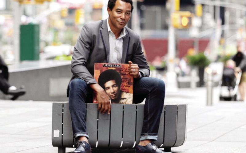 Singer Charl Brown poses on a New York street with one of Smokey Robinson’s record albums. CONTRIBUTED