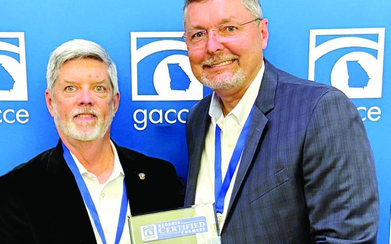 E-PCOC President Robbie King (left) receives a plaque from GACCE Immediate Past Chair and Dublin-Laurens Chamber of Commerce President and CEO Heath Taylor recognizing E-PCOC as an “outstanding” Chamber of Commerce in Georgia. CONTRIBUTED