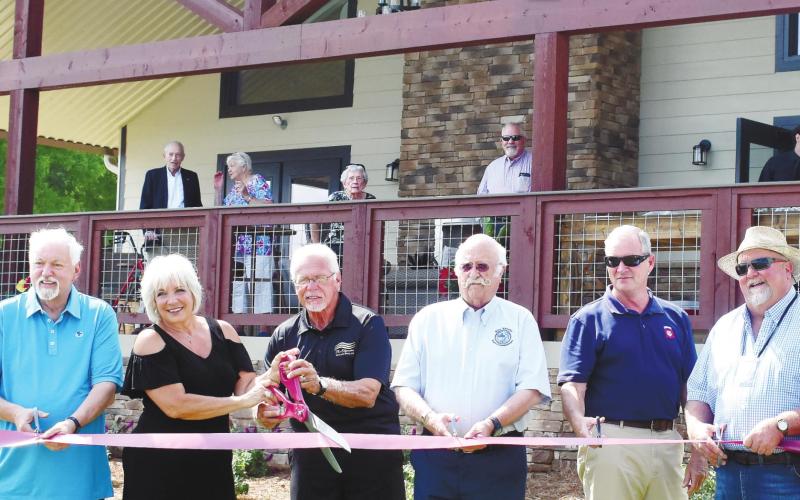 County commissioner Bill Sharp, park managers Susan and Lonnie Campbell, Commission Chairman Billy Webster, County Manager Paul Van Haute and Commissioner Jeff Wooten cut the ribbon. BAILEY BALLARD/Staff