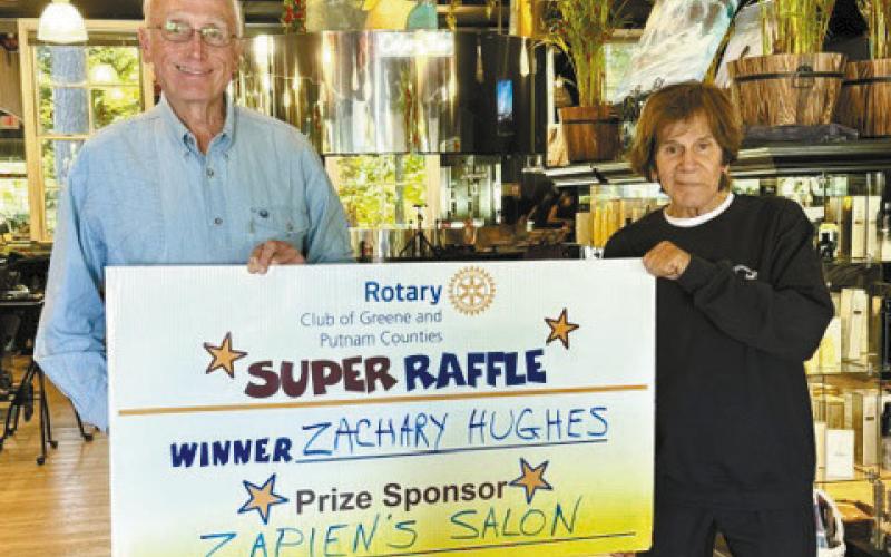 Rotarian Ed O’Neal (left) and Norman Zapien presented a $400 gift certificate for salon services at Zapien’s Salon; however, Rotary Raffle winner Zachary Hughes was not available for the photo.
