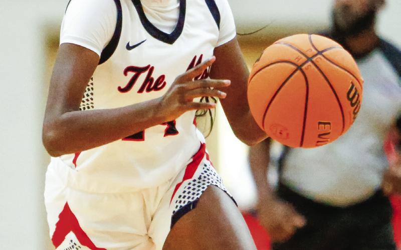 Senior Jaikarccie Smith dribbles the ball past defenders for the Lady War Eagles during a game earlier this season. LANCE McCURLEY/Staff