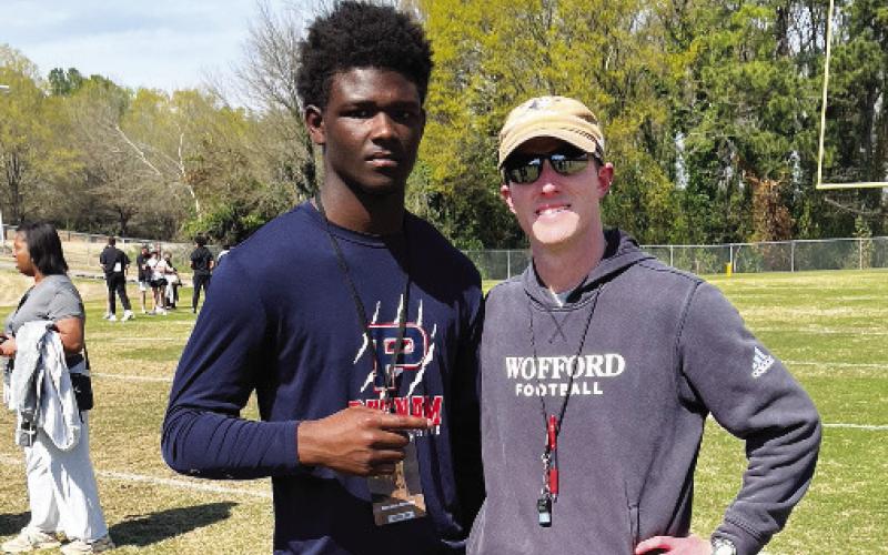 Putnam County junior Bryson Brown (left) with a coach (right) from Wofford University during a practice. CONTRIBUTED