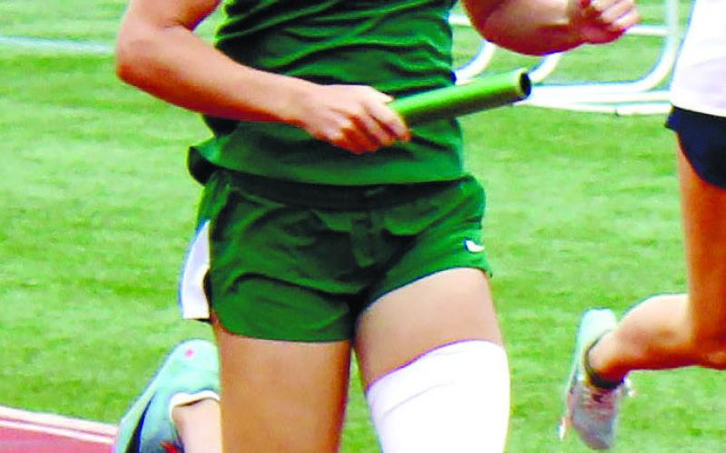 Natalie Sills during her leg of the 4x100 meter relay at the state meet. TREY NORRIS/Staff