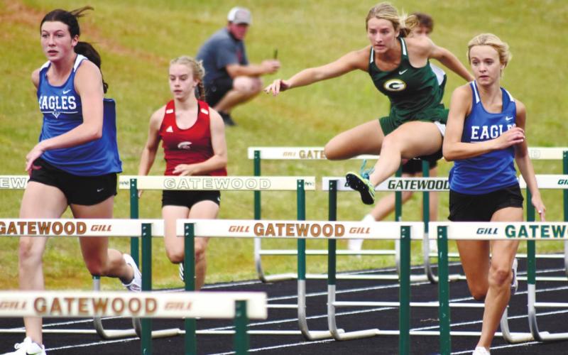 Anna Williamson clears a hurdle in the 100-meter event. T. MICHAEL STONE/Staff