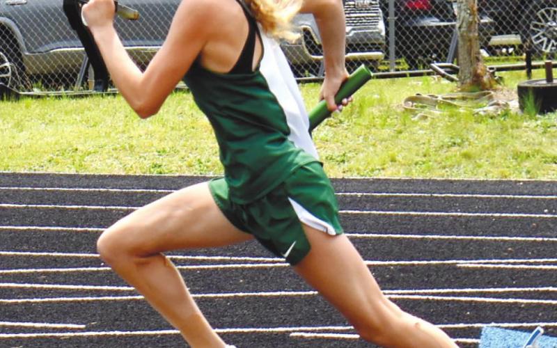 Presley Moss begins the girls 4X100 relay. T. MICHAEL STONE/Staff