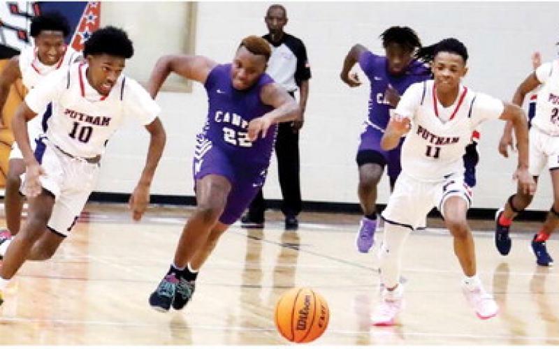 Completing a steal are Quinn Harden (10) and Messiah Walker (11). ARELLA CASH/staff