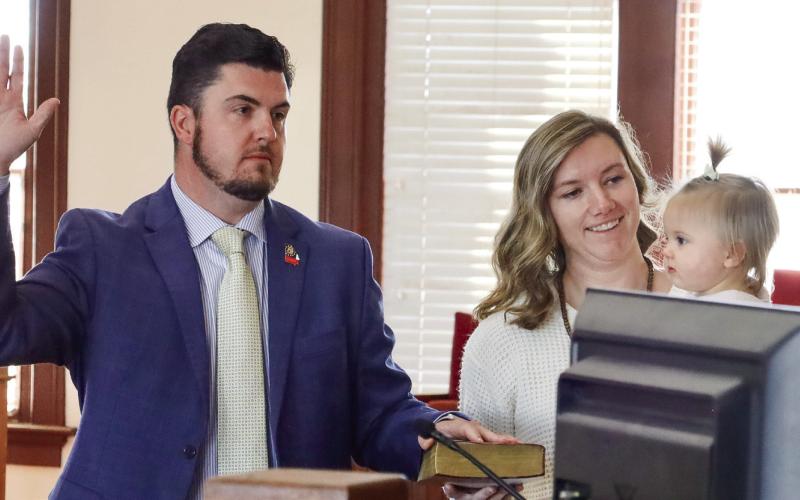 Putnam County Clerk of Courts Trevor J. Addison takes his oath of office alongside his wife, Pelar, and daughter, Cora. CONTRIBUTED/Alyssa Martinez