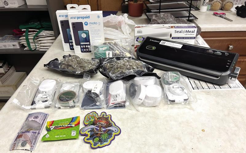 The vacuumedsealed bags of marijuana, cell phones and tobacco products intercepted by Eatonton police officers is displayed on a table. Also, the sealing equipment and other drugrelated items were seized. CONTRIBUTED/EPD