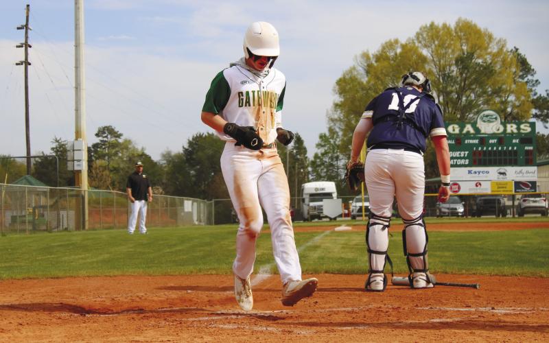 Lawson Wooten (15) reaches home standing up to score another run for the Gators. TREY NORRIS/Staff