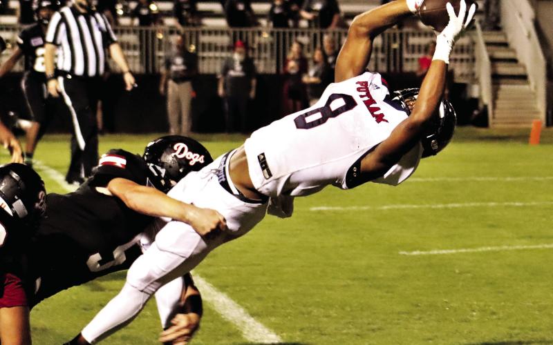 Cedrion Brundage bends over backwards to break the goal line plane and score Putnam County’s first touchdown of the 2021 season against the Morgan County Bulldogs, leading to a 37-0 rout. (File Photo)