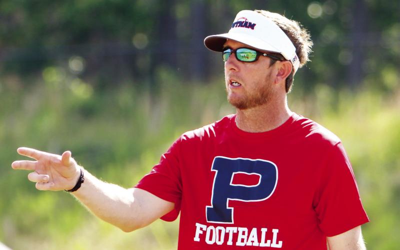 Putnam County head football coach Joel Harvin directs the offense during a recent summer practice. (LANCE MCCURLEY/Staff)