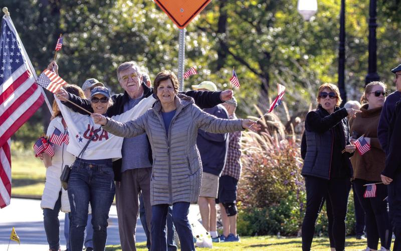 Supporters await the bikers at the entrance to Harbor Club. LEIGH LOFGREN/Staff