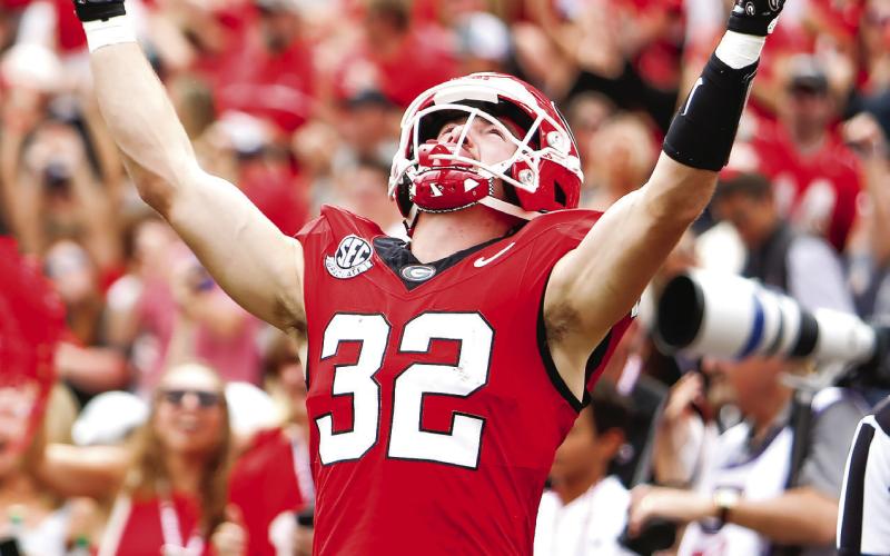 Georgia running back Cash Jones celebrates after scoring a touchdown against the Wildcats. LANCE McCURLEY/Staff