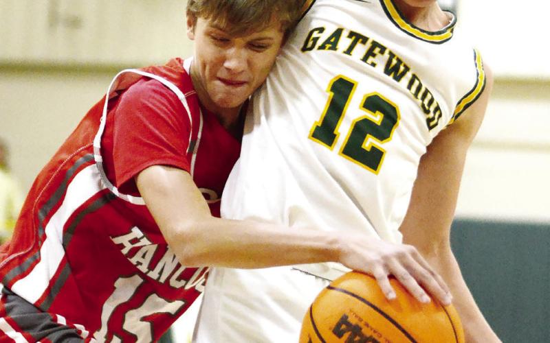 Sophomore Matt Allen (12) defends a shot from a John Hancock guard in the post. IAN TOCHER/Staff