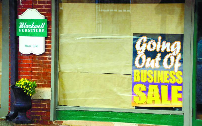 Signs outside Blackwell Furniture tell the story as it winds down after 78 years in business.