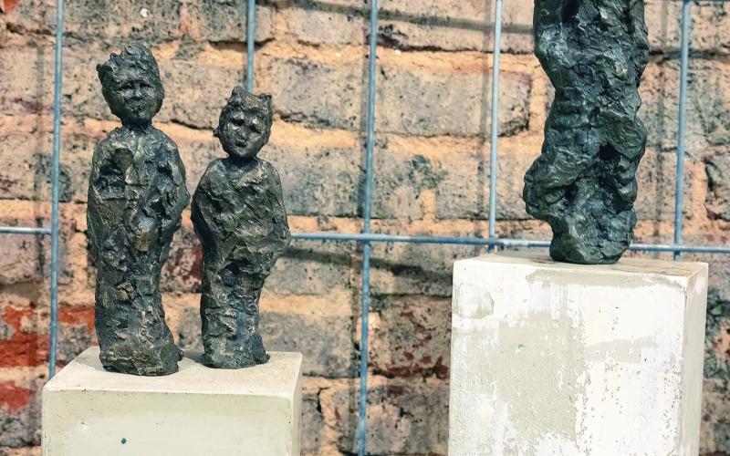 Two of the sculptures on exhibit, “Brothers” in bronze, wood and concrete, and “Despairing Boy 4” in bronze, concrete and steel, share similar styles and construction. LEIGH LOFGREN/Staff