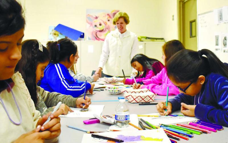 Kids make “Thankful feathers” under the guidance of instructor Nancy Marshall. As they color the feathers, they also write down things that make them feel thankful.