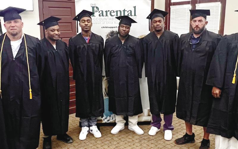 L-R: DCSS Assistant Deputy Commissioner John Hurst and Judge Brenda Trammell pose alongside PAC graduates George Hulsey, Mel-Juwan Lawrence, Bashun Carter, Gregory Burke, Michael Peek, Clarence Hill, Marcus Mathis, Judge Alison Burleson, and PAC Coordinator Zaccino Holmes following Friday’s Parental Accountability Court graduation at Putnam County’s historical courthouse. Not in attendance: PAC graduate James Brock.