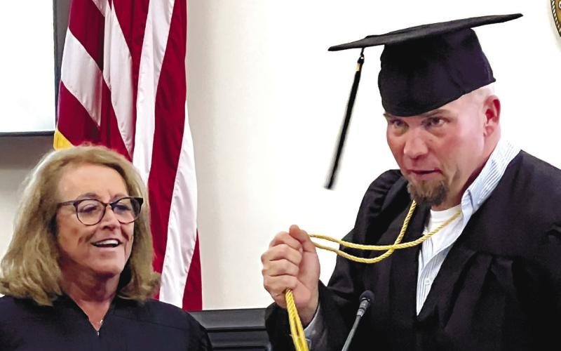 Judge Brenda Trammell and PAC graduate George Hulsey share a moment shortly after Hulsey gave an emotional and heartfelt keynote address.
