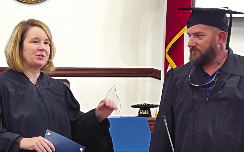 Judge Burleson welcomes PAC grad Clarence Hill to the podium, where he thanked her for helping get his life back in order.