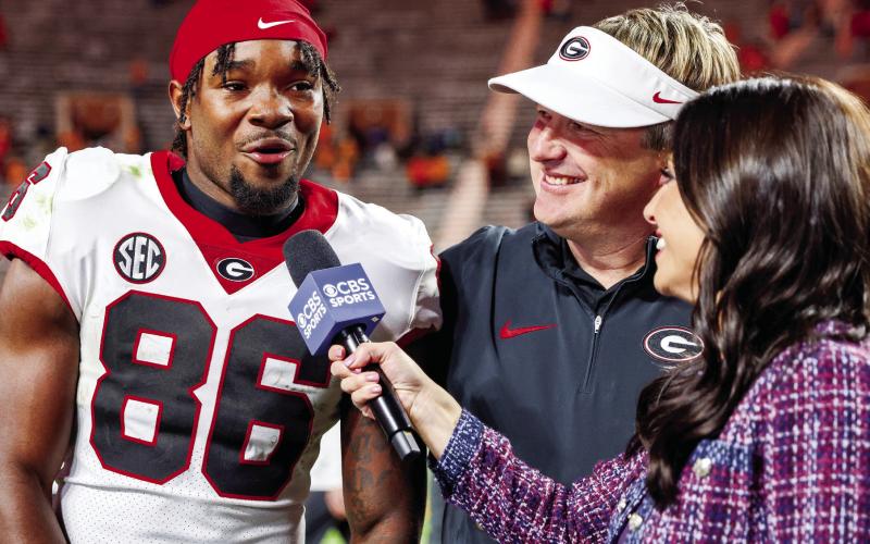 Sophomore wide receiver Dillon Bell threw a touchdown pass, caught five passes for 90 yards and a score while also recording one rush against Tennessee in Knoxville Saturday. Head coach Kirby Smart looks on with a smile during Bell’s post-game interview. COURTESY OF UGA ATHLETICS