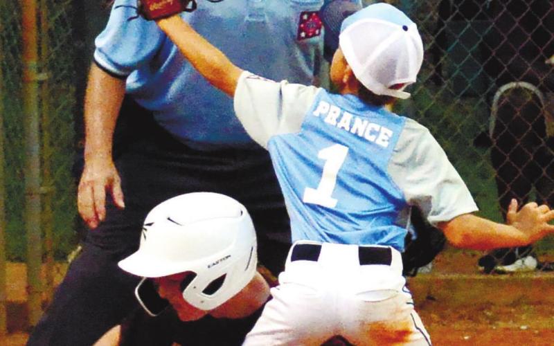 A Putnam player goes up for the ball in an attempt to tag out a runner. CONTRIBUTED