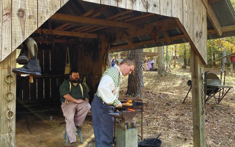 Smiths working in the blacksmith shop were making a leaf-shaped pendant for a necklace or keychain. EMME CLAUSE/Staff
