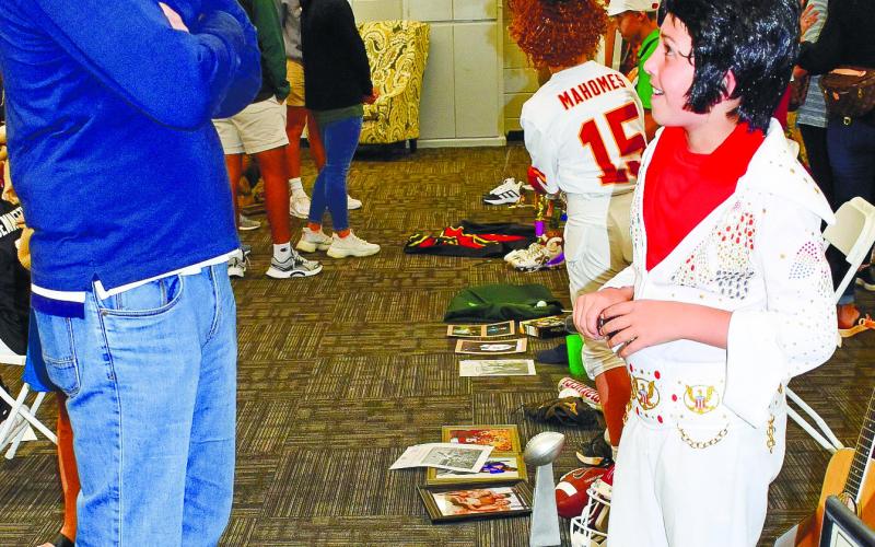 Dressed as Elvis Presley, Clyde Thrift answers questions about his character from Matt Miller.