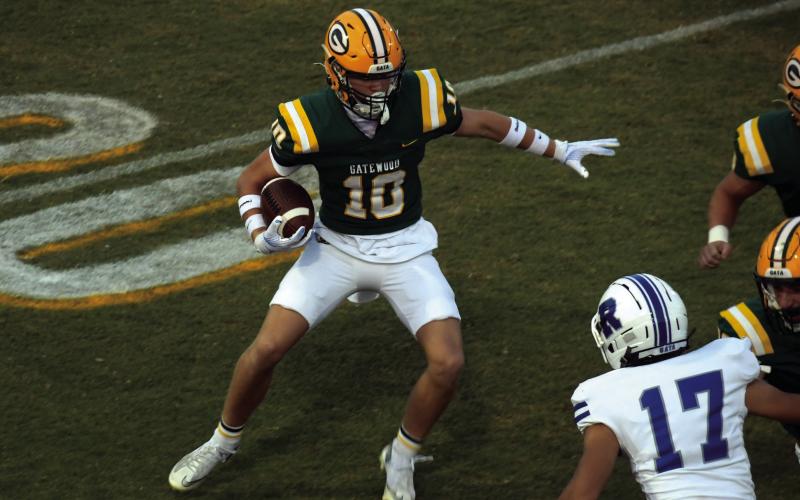 Gators junior running back Blake Brannen (10) gets behind a couple of blockers as he makes a first-quarter run last Friday at home against Riverside Military Academy.