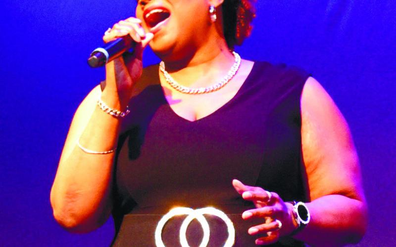 Loretta Hampton performs the National Anthem. LENA HENSLEY/Staff