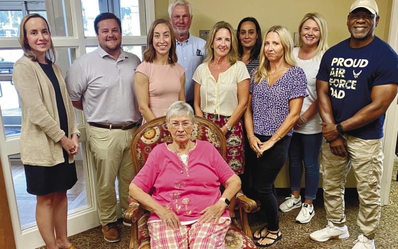 Glenda Ridley (seated) is supported by (l-r): Secretary Laura Gailey, Vice President Wil Ha-ley, Maggie Milner, Mike Rountree, Kelly Beasley, Rachel Harvey, Heidi King, Susie Noles and Bobby Lewis after her announcement of stepping down as a Putnam General Hospital Foundation member. CONTRIBUTED