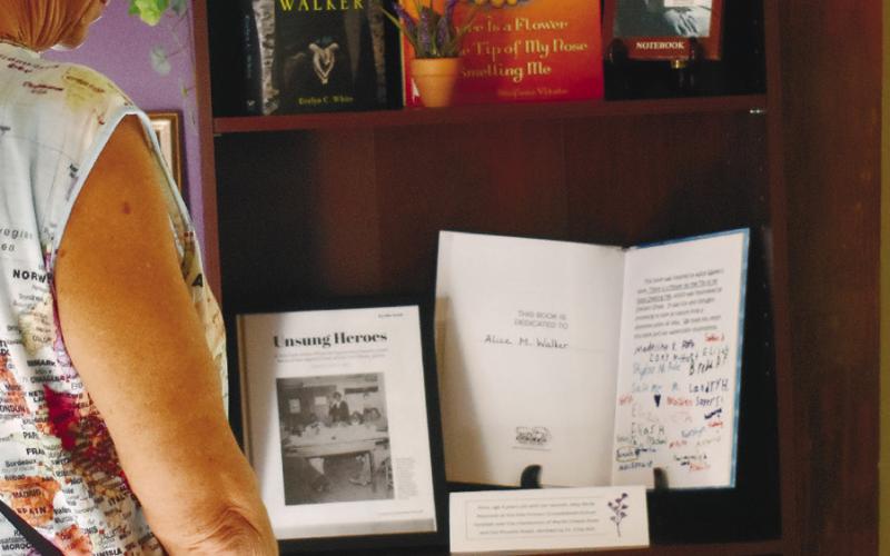 A visitor to the museum reads about Alice Walker visiting the local library and how she impacted local children during her visit. BAILEY MCCULLY/Staff