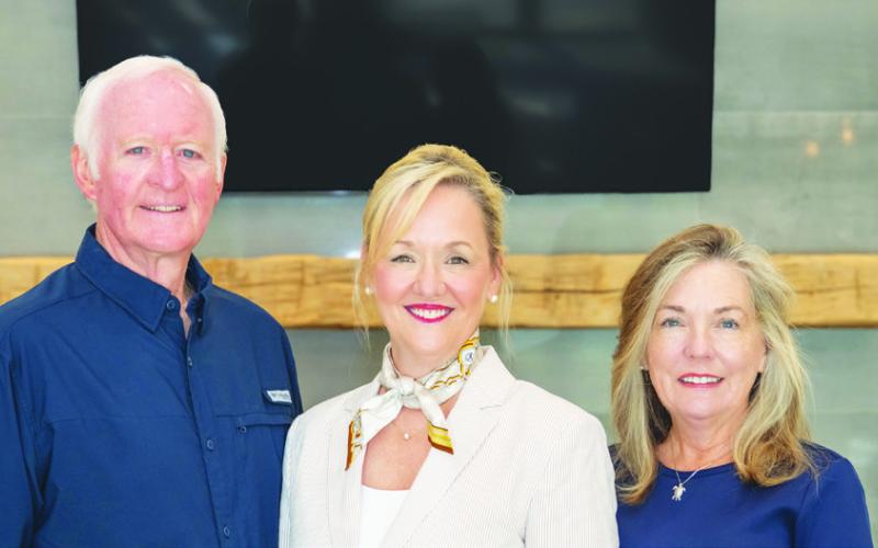Reynolds Lake Oconee Properties sales leaders Scott Hoersten and Mary Luster (right) joined 16time Sales Executive of the Month Traci Johnson for a celebratory photo. CONTRIBUTED