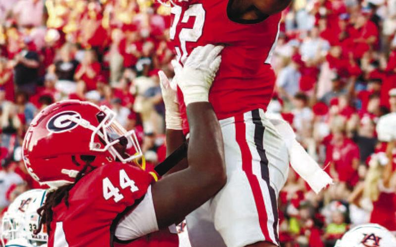 Georgia freshman running back Branson Robinson (22) got his first touchdown in Sanford Stadium Saturday against the Auburn Tigers. He was also the leading rusher in the game. LANCE McCURLEY/Staff