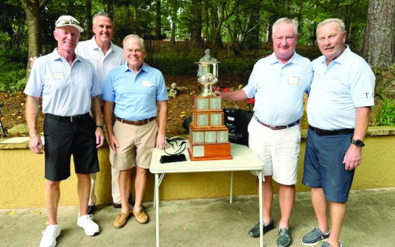 Standing around the coveted Oconee Cup trophy are, from left, Tim Joyner, Tom Clement Jr., Steve Cross, 2024 Commissioner Pat McNabb, previous Commissioner Gerry Giesler. (CONTRIBUTED)