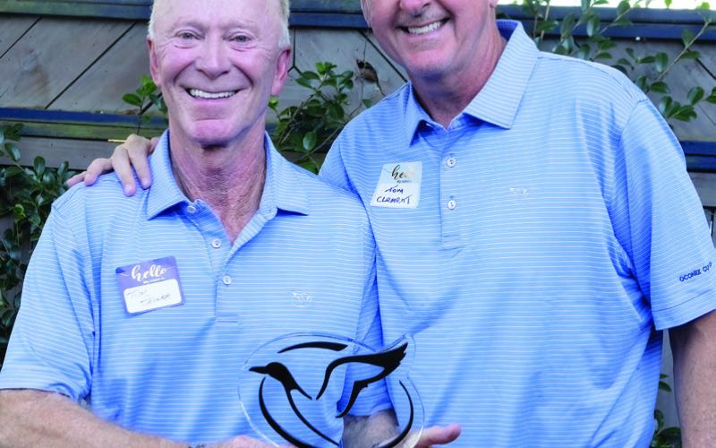 Team Captain Tim Joyner, left, is awarded the annual Tom Clement Award by Tom Clement Jr., son of the award’s namesake. (LEIGH LOFGREN/Staff)