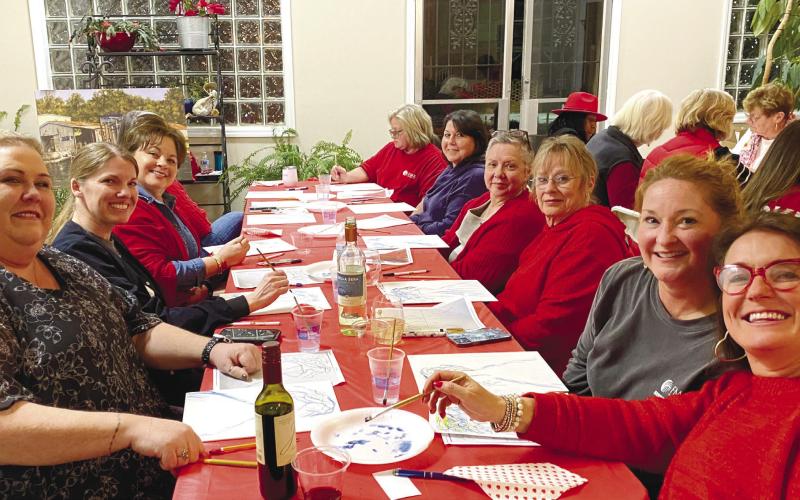 Local women gather to wear red and participate in painting for the Go Red for Women campaign. CONTRIBUTED