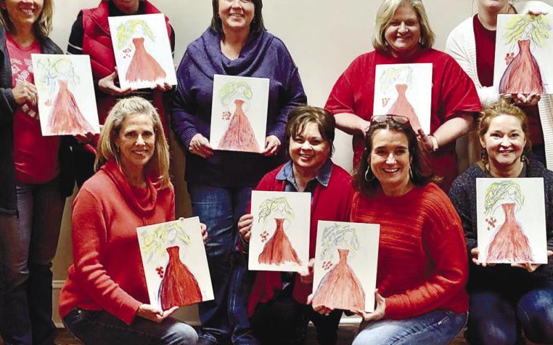 Group 1 shows off their red dress paintings at Putnam General Hospital. CONTRIBUTED