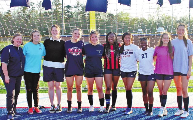 Coach Barling stands with her seniors: (l-r) Tesa Shelton, Andie McMahan, Cambell Crouch, Viviana Orduna, Nevia Allen, Lali Cardenas, Breshyia Farley, Nicole Bibita and Courtney Davis. ARELLA CASH/Staff