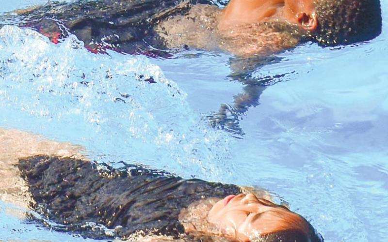 Fifth-grader Jennifer Sanchez and third-grader Christian Harper demonstrate their backstrokes.
